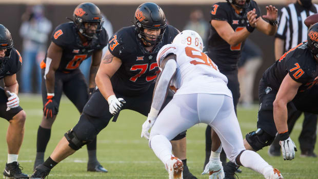 Oct 31, 2020; Stillwater, Oklahoma, USA; Oklahoma State Cowboys offensive lineman Teven Jenkins (73) blocks Texas Longhorns defensive lineman Moro Ojomo (98) during the fourth quarter at Boone Pickens Stadium. Mandatory Credit: Texas won 41-34. Brett Rojo-USA TODAY Sports